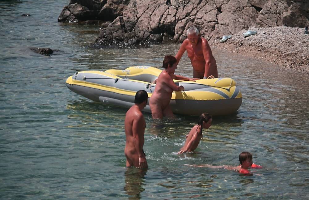 Lone Nudist in Yellow Boat photos - The practice of nudism helps to overcome stereotypes and insecurities