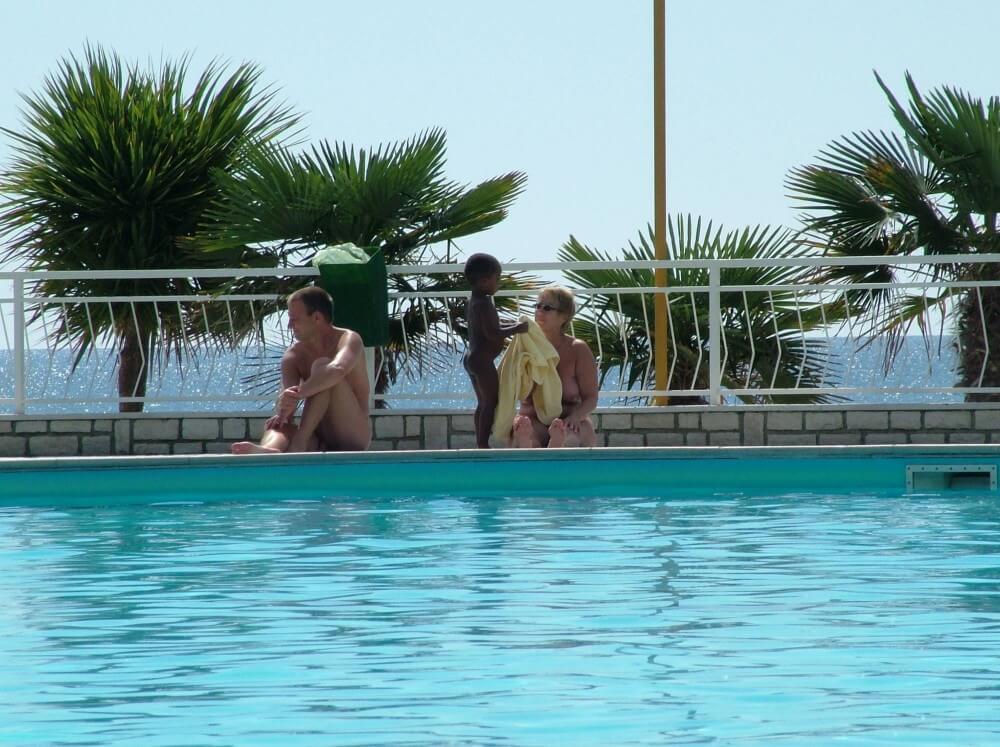 Photo of naturists in an outdoor pool - Freedom as the core principle of naturism